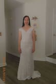 I wasn't sure how a mail-order dress would work, but I decided to give it a try. I'm very pleased. It's very pretty and fits well. It may be a little long, but with heels, it should be perfect. The train in the back is also a nice touch. The lace "sleeves" will require a strapless bra. I'd say this is definitely a good choice if you are a petite woman looking for something elegant, yet inexpensive. - Sherry E.