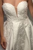 I normally wear a 2 and ordered a 4 and yet it was too small to zip up all the way. Very pretty top! The skirt on this dress was too much fabric for me so I went with another dress. Good if you like the more Cinderella-type dress! - Emma E.