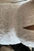This dress is ABSOLUTELY GORGEOUS!! The detailing thought out is sooo beautiful!! It fits like a glove & doesn't need any alterations. The thick straps makes me feel secure & the v neck is sexy but not to revealing. I loved this dress so much I sent my David's bridal dress back. Excited to wear it all night at my wedding. - Rose V.