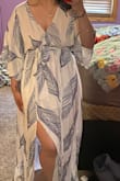 Follow other reviews and order a size down! I'm normally a large and I ordered a medium. It fits perfectly. I'm wearing it for my summer backyard wedding reception. The only downside is the underskirt is laughably short. Like, it literally stops just below my privates. So I most definitely will have to wear shorts or something underneath. A few loose strings but it flows great. Shipping was super fast! - Naiema S.