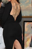 Got this dress to show off my back tattoo. I was worried because I have my share of rolls. Felt beautiful and contained without any undergarments. Definitely would buy in other colors, this is your new LBD!

The fabric is stretchy and thick, feels like nice quality and the structured back makes the dress look classy. I have broad shoulders so I didn't have any trouble with slipping. It does ride up a little if you are doing more active stuff like dancing. 

Would recommend it to anyone of any age or body type. - Willow C.
