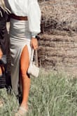 This skirt is the perfect piece to your summer wardrobe! The length makes it dressy, but the slit makes it fun at the same time! I ordered a medium, and it fit me perfectly! Keep in mind that there isn't much stretch or give to this skirt, however. Pairs perfectly with a crop top or bodysuit! - Alexis J.