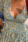 I wanted to love this dress but the fit in the breasts was so off. The chest area that holds the girls in was open and loose and the fabric on the inside was popping out. Such a bummer. And it wasn't tight at all so I couldn't understand why the fabric was popping out. Just poorly made. 
I don't know if all of these dresses are like this or maybe it was just this one. Other than this area of the dress, it fit fine everywhere else so I wouldn't size down because that would probably be too small. I put some pins on it and I'm gonna sew the area so it stays together and the fabric doesn't pop out. I'll update my review of the results once I finish. 

It really sucks to buy something and to have to alter it. Not a fan of this.

So I'm updating this review cause I stitched the opening of the chest area and it's so much better. Now I can actually wear it without my breasts popping out and I'm not scared of some cleavage but this was just poorly made. 
Just beware. - Dana S.