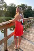 I received soo many compliments on this dress! I'd say it runs true to size. The bow is a little tricky to figure out but it doesn't have to be perfect when you tie it. No one will notice the bow is perfectly tied or not - they notice the dress and the open back! - Stephanie R.