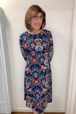 What a lovely dress!  The floral print is absolutely beautiful!  The fit is true to size.  I ordered the medium, and it fits well, but there is no stretch to the garment, so keep that in mind.  Also nice to have a modest but ravishingly beautiful and attractive dress!  Recommended! - Jo N.