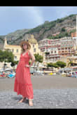 I bought this dress for a trip to Italy and I couldn't be happier. It has a beautiful flowing chiffon layer that has iridescent gold print, and was perfect for a lunch at a fancy patio in Positano. The dress is fully lined which made it heavier than I thought it would be to wear on a warm summer day, but the quality of the dress was great. It packed well and didn't even require steaming. It has an open back, but because of the lining, the dress can be worn braless or with a sticky backless/strapless bra. Loved it! - Katherine R.