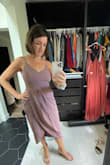 I loved this dress but the color in the photo is very misleading.  I was supposed to wear a pink shade for a wedding but this is much more purple.  The fit was phenomenal... so I was bummed that the color wouldn't work.  I recommend this dress but be aware the color is very different.  (To note, I wouldn't have been able to fit a bra underneath this dress... it was pretty snug.) - Maggie T.