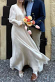 I wore this for our courthouse wedding a few months before our wedding party and I absolutely loved it! It was a tiny bit loose in the chest and long so I would have sized it down if I were to reorder it. It is simple and elegant and I loved the cream color with the button details. - Valkyrie Y.