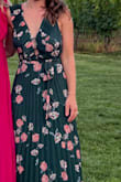 I love the way this dress hangs. The floral pattern was perfect for the event. The detailing with the back tie, ruffle sleeve detail, and center buttons were wonderful.  Skirt hangs and flows, And allows you to still feel comfortable if you eat a big dinner.  I had many compliments. - Elizabeth E.