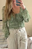 This shirt definitely, as other reviews mention, runs slightly large. It must be made for some busty ladies because I have to tighten the top part so much to make it fit!! I usually wear size M and thus overall fits, but is just slightly too big all around, especially in the busty region. The positives are that you can adjust that part of the shirt. - Hillary J.