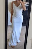 The dress is plain and simple! Figure-hugging and not forgiving would be hard to wear with shapewear. Not for me, might look nice with a belt or accessories. I am between size 4-6 and went with a medium. - Adriana C.