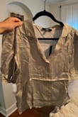 Such a cute style top, just tragically wrinkled. I will need to invest in a commercial steamer because my travel steamer isn't cutting it. It is a crop top and does not stay tucked in well. - Vanessa B.