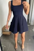 As someone who has more curves than the model in the pictures, I think this dress look way more flattering on my body shape. I'm a champagne ambassador, so I wear it for my work day and rock it to a classy dinner with a client afterwards. It is tight the way I want it to be and I don't need to wear a bra with it. The dark navy color is very classy. - Oyku S.