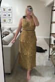 Bought this dress to wear to a black tie optional wedding. I am typically a M/L on top and L/XL on bottom and the large in this dress fit perfectly throughout my waist/hips! Top part is a little bit but should be an easy alteration. Quality is great & it's a flattering dress. - Reagan P.