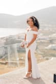 After a complicated process of finding what dress I wanted for my wedding portrait, this dress came in the save me and my wallet. The second I try it on I knew it was perfect. I did not have a wedding but took wedding pictures in Greece. The material is tick and has a decent stretch. Easy to travel with and doesn't wrinkle. The length was perfect for me. The sleeves can be a little restricted but that's normal for an off shoulder. Simple and elegant. it was perfect for what I wanted. - Massiel L.