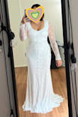 Dress has beautiful lace and is very light fabric weight so it does not feel heavy at all. Easy to put on by myself and comfortable to move in! The dress is not tight around the hips or thigh area. Perfect dress to wear for my January elopement in cold weather! - Renee G.