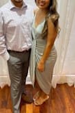 Wore this for a wedding and this dress really showed my curves while hiding the belly! I had to have the chest area stitched because it is a little plunging, but otherwise the fitting is nice! Had to get extra small since I am short (50). - Hannah B.