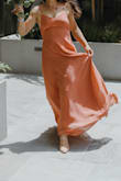 Super soft and a perfect terracotta orange color. It was a little loose around my chest and 1 inch or so too long with heels. My sizing recommended a medium but I bought a small and I'm glad I did. It was a perfect last-minute bridesmaid dress and literally arrived 2 days before the wedding. Thank goodness. - Sofia W.