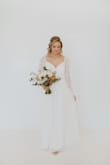 I first purchased this from Lulus as a backup wedding dress. I knew I was having a small studio wedding with 40 people, and when I saw this dress I immediately knew I needed to at least try it on. It came, I tried it on, and I LOVED it. However, I wanted to try on a few other dress to make sure. I went to a few boutiques and found another gown (for much more $) and purchased it. I did love it. But, one week before the wedding, I tried this Lulus dress on again and was reminded how I felt completely myself in it. I decided not to wear the $$$ gown and instead wore this! This dress truly is romantic - it is also SO soft. The lace sleeves were my favorite element, and I received endless compliments on the dress the entire evening. I didn't have time to get it tailored, but honestly it fit pretty well without any alterations. If I had had more time, I would've added bra cups and perhaps taken it in around the waist. I can't recommend this dress enough! - Macaylah M.