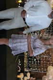 This dress was great for a hot summer wedding. The fabric is thick but not too bad and it feels silky and flowy. If you are bigger busted you may have to get a low back bra because the back is open a bit with the slit and tie, but was not an issue. It was slightly short but I'm glad I went with the XS! - Karissa M.