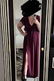 I bought this dress for a special dinner while we were on vacation. If I had had time, I would have exchanged it for a smaller size. I'm an l bout a 12 in normal street clothes, but dresses are challenging. I'm this is large; with the stretchy waist, I think it would have looked better if it were more fitted. I'm also losing weight, so it would have gotten more use if I went with a medium. It is pretty low cut, but I'm sure it could be pinned to be more modest. I left it as is since nobody I knew would be seeing me. Loved the color and the slit. It would make a beautiful bridesmaid dress. Comfortable, breezy, affordable. I wore it in 100° heat and felt fine. - Sarah G.