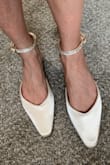 Very pretty shoes! Toe is long and pointed/narrow. Shoes have more structure than appears in the website photos. - Katelin Z.