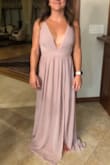 Love this dress!! It's a pretty deep v so beware but I love it. There may need to be spray tan before the day I wear this though. As a pretty petite person, I was surprised to need a small instead of an extra small. - Adriana A.