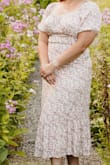 I picked this dress for a garden photoshoot & I loved it. The medium hugged me a little bit in the abdomen/torso area but I probably could have worn Spanx to smooth it out a bit. Very comfortable and airy. Good summer dress for a nicer occasion. - Ashley K.
