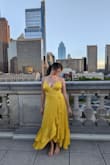 I absolutely LOVED this dress! It is simple and elegant and truly shines through its beautiful marigold color and it is flowy design. The only reason I give it 4 stars instead of 5 is because the bust seam didn't lay flat and kept turning out.

I love that it's low cut (get ready to wear sticky cups or no bra) and despite it being a bit bigger in the bust than I would expect, the true issue is that the bust part kept flipping over and showing the underside of the dress. I managed to fix this by using A LOT of fashion tape, but that only worked up to a certain point. If you look closely at other customer photos, you can see that the bust seam is turned over in many of them. If that was fixed, it would truly be the perfect dress. Regardless, I loved wearing it and felt a bit like a modern-day Belle from Beauty and the Beast. - Elizabeth E.