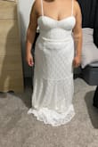 The dress it beautiful. Simple yet elegant. Good quality but unfortunately with my small stature and lack of torso just could not bring myself to keep it. Side note the cups on the bust are shaped strange and I was not found of that. - Tabbitha G.