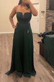 I loved how this jumpsuit looks on me from the top! However, I am 5'2 and know that it's hard for me to find attire that doesn't run too long. That said, I did have to get this jumpsuit hemmed. The tailor cut off about 4' from the bottom to have it fit me how it fits on the model (even with heels on). I got a medium due to my bust size. Regardless, wearing this for a wedding and I'm very happy with the fabric and fit overall. - Yasmin C.