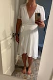 I love this dress! I love that it ties closed making it extremely versatile to your size and body shape. I eloped and was going to wear this as my #1 choice. But the issue I ran into was with the bust - if you have a larger bust and can fill out the top - the better. Going no bra you could see through it completely. Even with pasties on you could see the outline of my pasties. Every bra I put on it was so low cut you could see my bra at the bottom between the boobs. So then I tried some body suits but they all showed through and didn't match the exact white color. I feel body suits are a must or spanx or some kind though because the back (and butt) were very very see through as well. Wearing something under this like a cami or body suit to help cover up bust for someone with a smaller bust would be the way to go I think. Maybe if I had gotten it in another color other than white I would go braless. Didn't end up wearing it but still kept it for another time. - Katie A.