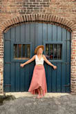 Very flattering. A little large on me at the waist (Sits more at the hips, but I prefer not showing my belly button)- so I took it in about a quarter inch on each side (just at the waist). Probably could have gotten away with an XS or Small. Lots of complements on this skirt! Top and hat are Lulus too. - Ashley W.