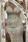I bought this for my reception and am kind of in between a L and XL. I bought the L and it DOES fit. Just a little snug but hopefully I'll lose a couple of inches by the wedding. It's beautiful and sparkly. Very flattering and stretchy. Hugs the curves! - Leslie I.