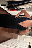 Very very low cut, If you have a chest your breast will be showing. The slit is not a true slit, it is a wrap dress so it's not how it's pictured. - Tiffany M.