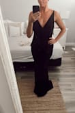 Beautiful dress. I went up a size (size large) as I have a small upper body but big hips. I got it taken in and hemmed at the bottom. Either way you will likely need it hemmed. Stretchy material which is ideal. - Katie N.