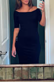 This dress is very pretty. The off-the-shoulder cut is really pretty and flattering. The slit in the back isn't so bad but perhaps would not work for tall people like me in more conservative professional spaces. - Raquel M.