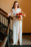 I had tried on a much more expensive lace gown at a bridal shop, and was over-the-moon excited when this dress arrived and was just as beautiful!! It fit me great and I have received so many compliments. I did have my mom alter the neckline by stitching it up an inch to not be so low cut. It was a little long and dragged on the floor, but worked for a bridal gown. The leg slit is pretty high, and halfway through the day I found myself wishing I had my mom alter it, as well. - Ginny E.