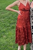 I wore this dress to a wedding and received tons of compliments; the color is vibrant and exactly what it appears in the photo, and the pattern of the fabric is so beautiful. I ordered a small as suggested by the size chart, and it fits almost perfectly except for the bust. The chest area of the dress is fairly unstructured, so unless you can fill it out there will be a lot of excess fabric. Definitely needed a bra for this! Don't hesitate to purchase it otherwise, it's a gorgeous piece! - Maria C.