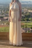 The dress is beautiful. It runs very big. I ordered a medium, but after trying it on, I ordered an xs and had to wear 5" heels or get it altered. The seams make it a little hard to get the wrinkles out, but I really love the fit and fabric. Great quality. - Bobbie S.