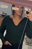 I loved this sweater. It fit true to size. I love the color. It was long enough for my long arms. I wish the V-neck was a little bit more V shaped, when I put it on it kind of turned into a U. - Nicole I.