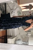 It is as stunning as the picture, but I ordered an XXS only because they were out of XS. I wanted to see if I liked it in person and then would return and get the XS. But, the XXS is too big. There is at least 4 inches of space around my waist, so the dress makes me look bigger. I am pretty petite but was astonished to find an XXS that was this big. Would totally recommend it to someone that can fit into it. - Sophia K.