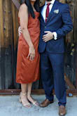 Material and the way it lays is very forgiving. The little bit of pleating helps to hide tummy and gives dress a different look. Modest length, but slit opens all the way when sitting. - Andi S.