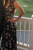 I bought this because it was a shorter maxi dress and as a short human I didn't want to have to pay to have a dress hemmed. The length was perfect and I wore 3" nude color heels. I am petite with zero curves and have a small chest so the deep V cut was tough to fill out and I needed double-sided tape to avoid a flash show at a wedding. I will need to have the front sewn together to wear it comfortably without having to dance with my hand on my chest. By the end of the night I had to unzip the back a bit because the waist has no give even though there's a sash. You will need to have someone tie the string on the upper back part for you. I didn't feel it warranted the price but I'm hoping to get another wedding usage out of it next year. - Rudi M.