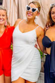 Perfect little white dress! I was looking for something cute but a little sexy for my bachelorette trip and this fit the bill perfectly. Wore it out to a party/boozy brunch, and it was very appropriate for that venue. It is a little snug, but sizing up would not have given the sexy look I was going for (so, that said- if you need to be a little more modest and you are on the curvy side like me, size up). I loved that I could wear a strapless bra with this! It has no support on its own, so you can easily wear a strapless bar without issues. I also bought this in black and havent worn it out, but it is also perfection. The ruching and drape across the front is super flattering and perfect for hiding a low tummy pooch. If you need a dress that gives a classy, sexy edge - this is THE dress! - Tiffany N.