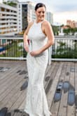 This dress made my wedding dreams come true! I immediately fell in love with the style and design. The beading, sequins, and embroidery are gorgeous! It may sound like a lot but this dress is so elegant. My only complaint is there was some slight gaping of the fabric on my shoulders that I couldn't fix with fashion tape. I'm 5'9" and wore 3.75" heels which were perfect with the length of this dress. - Jessica L.