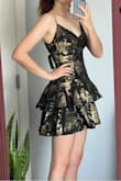 Overall a very nice dress! The material seems sturdy and looks beautiful. The gold is very flashy, I love it. The dress is pretty true to size, but is a little large on the lower back area for me. Be warned, it is short. = I felt pretty in it, would recommend! - Elise R.