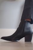 The look: sexy villain (in the best way possible). I love these shoes peeking out from a wide-leg or bootcut pant. They make me feel hot and powerful.
The arch is high and smooth which cradles my feet so there is not that dreaded gap, which would have me on my toes all night. Instead, these boots are well-made, and massage your feet with a smooth leather feel on the interior. The sizing is on point quite literally as the tip of the shoe goes out beyond the toe box making them spacious for your little paws. The ankle does take some getting used to but these are beautiful, well constructed. Buy um. - Xena H.