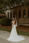 Instead of going to a bridal boutique, I ordered several Lulu's wedding dresses and my bridesmaids created our own "at-home" boutique for me to try them on. It was such a good time! I ended up keeping 3 of the dresses -- one for my rehearsal dinner, one for my ceremony, and one for my reception. This was my ceremony dress and it fit perfectly. No alterations were done besides 2 small stitches at the top to hold the lace down to the shoulder straps. Would have no idea it wasn't $5000! I paired it with a plain cathedral veil and about 3 inch heels. - Madison B.