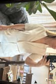 This top is a little low cut.. i would either wear something underneath, put a stitch in it or maybe tape. It does have a little bit of a stretch for my wide shoulder girls! - Sedona A.